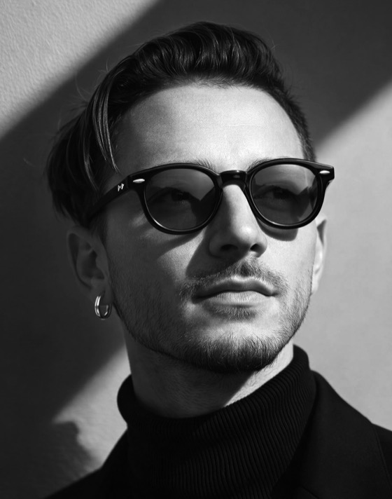Black-and-white portrait of Roman Bordo wearing sunglasses.
