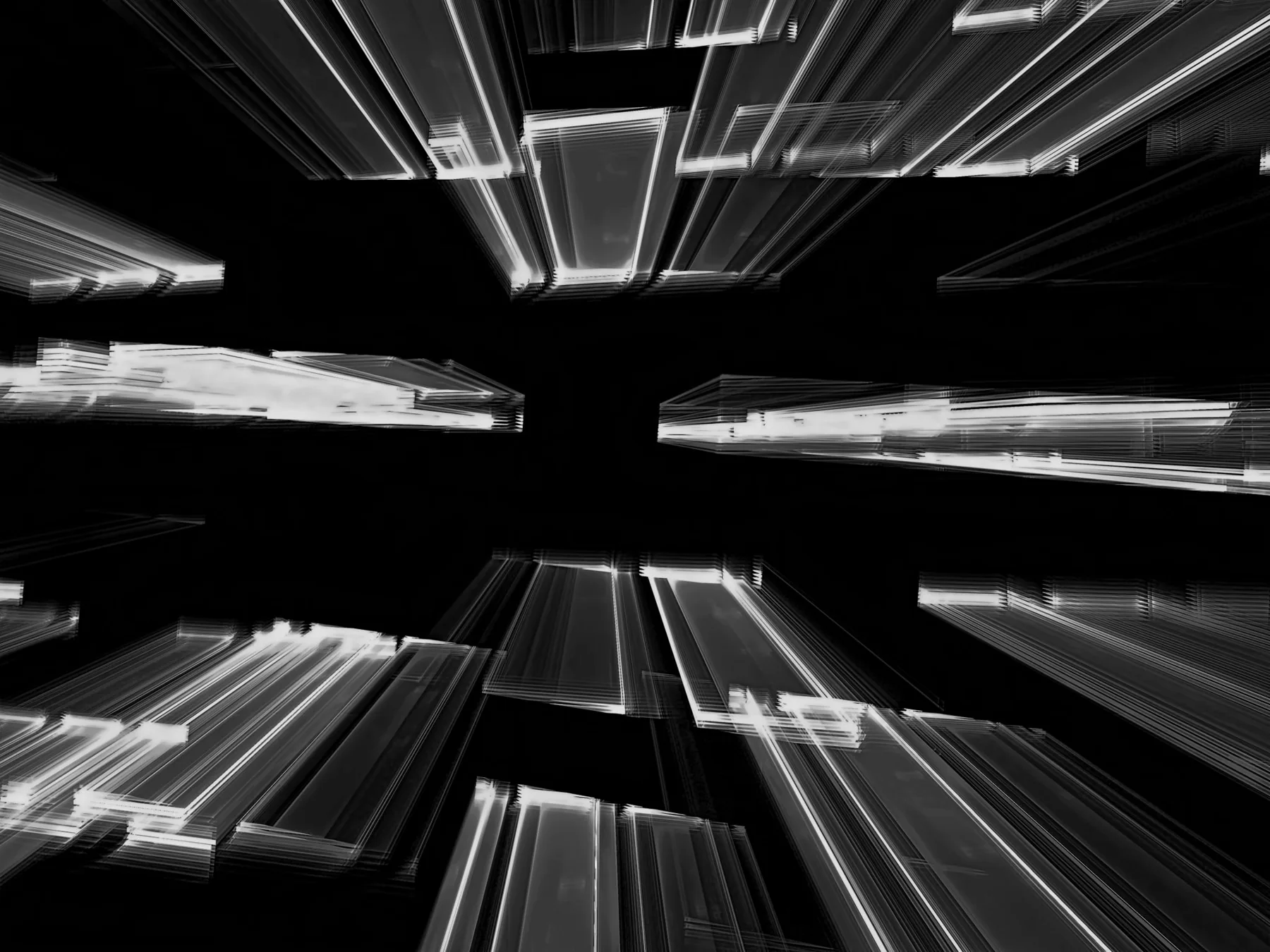 Abstract streaks of light moving through a dark spatial composition.