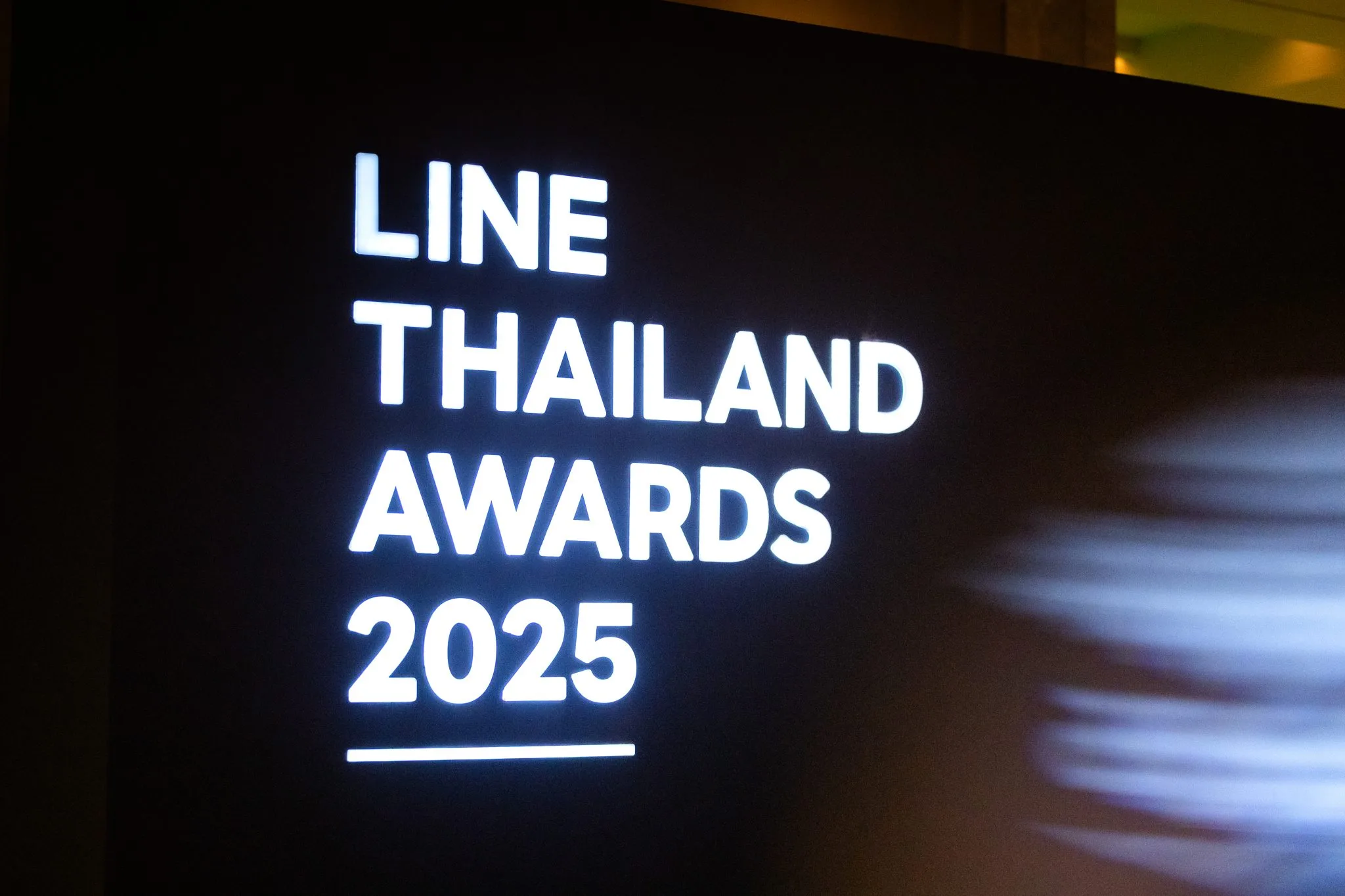 Awards identity projected inside the venue.
